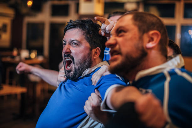 istock Fans watching game together in sports pub 1157711471