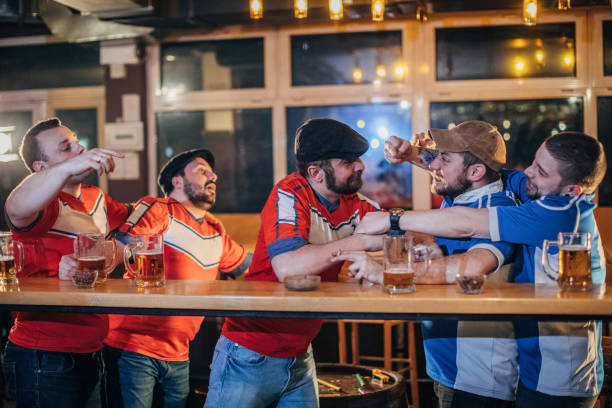 istock Group of fans fighting in pub 1157711603