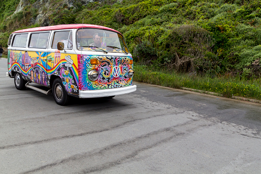 San Francisco, United States: May 12, 2019: Painted Volkswagen van in vivid colors driving in the street in the city of San Francisco