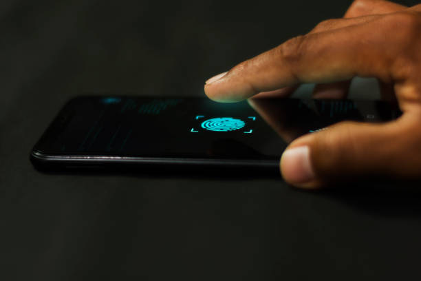 istock Man holding smartphone with fingerprint scanners to system connect to the database via security system high technology. 1157713747