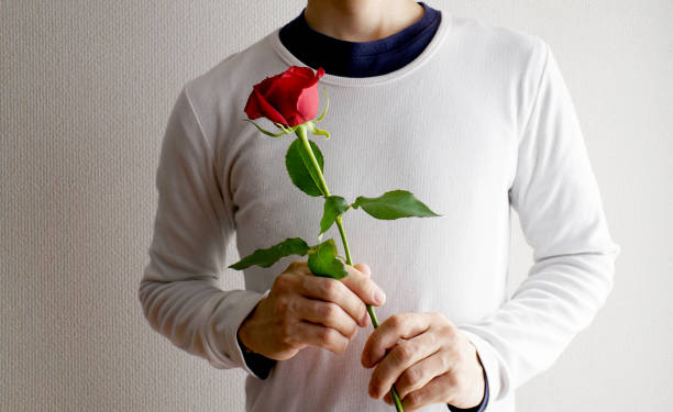 istock Men handing flowers a present. 1157715196