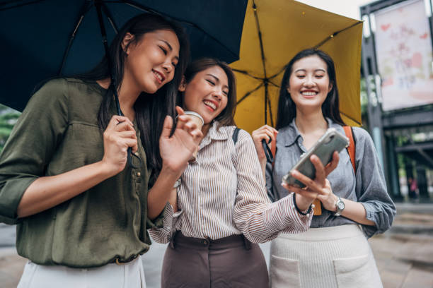 istock Women using smart phone on the street 1157715540