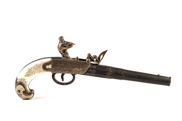 Flintlock pistol Flintlock pistol with engraved handle over a white background rifle old fashioned antique ancient stock pictures, royalty-free photos & images