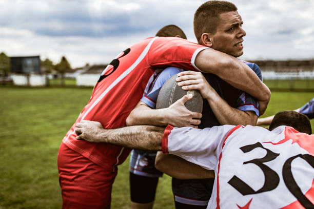 istock Aggressive rugby players blocking their rival on a match at playing field. 1157720918
