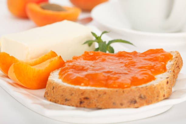 istock Bread slice with butter and apricot marmalade for breakfast. 1157721584