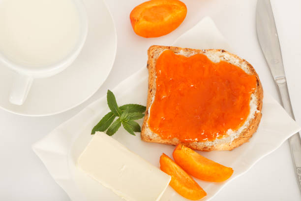 istock Bread slice with butter and apricot jam for breakfast. 1157721761