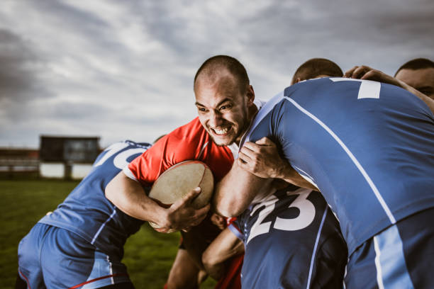 istock Aggressive rugby player making an effort while trying to pass his rivals on a match. 1157721932