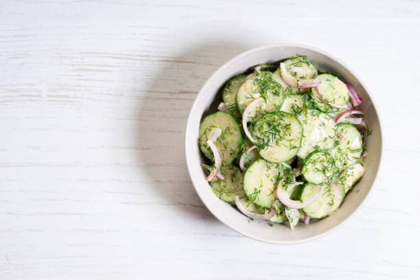 Cucumber and red onion salad Cucumber and red onion salad on white wooden background chopped dill stock pictures, royalty-free photos & images