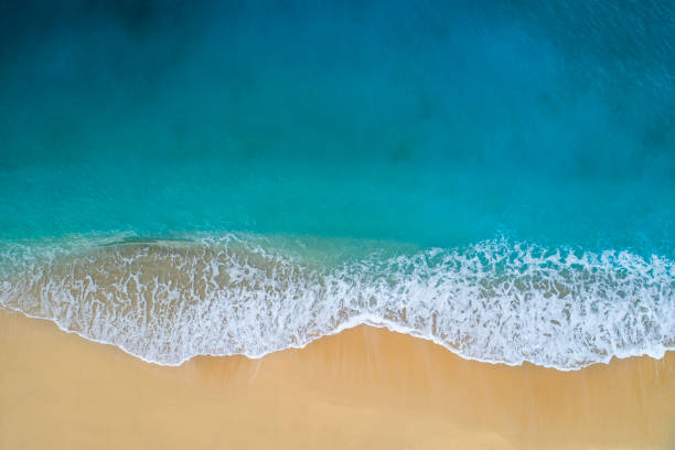 Aerial view of clear turquoise sea and waves Drone photo of waves and and sandy beach of Kaputaş. beach sand stock pictures, royalty-free photos & images