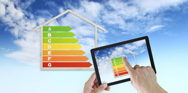istock hand touch screen of digital tablet with house shape and energy efficiency chart symbol, isolated on blu sky background, green buildings and save energy eco sustainability 1157726247