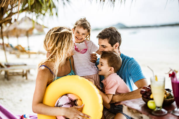 istock Happy parents having fun with their kids in a beach cafe. 1157726479