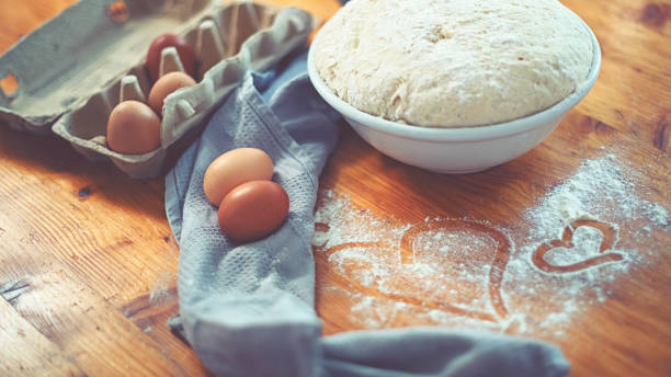 make a fresh yeast dough in the kitchen with love - proof of love imagens e fotografias de stock