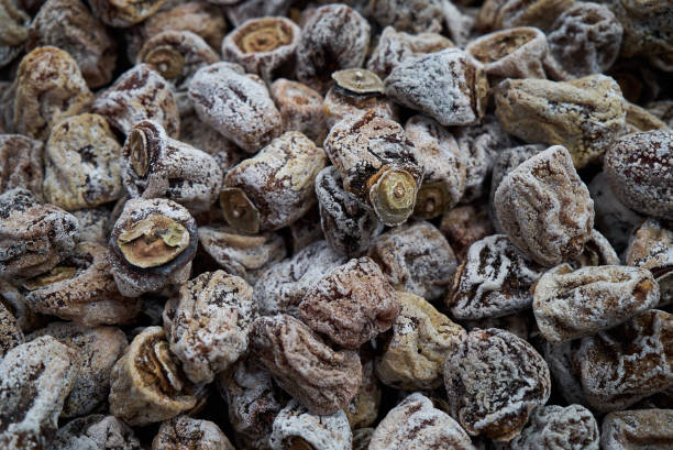 istock Dried persimmon texture background, close-up, top view. Preserved persimmon 1157726536