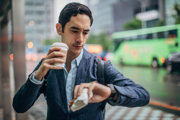 市内のビジネスマン - businessman checking the time men male ストックフォトと画像