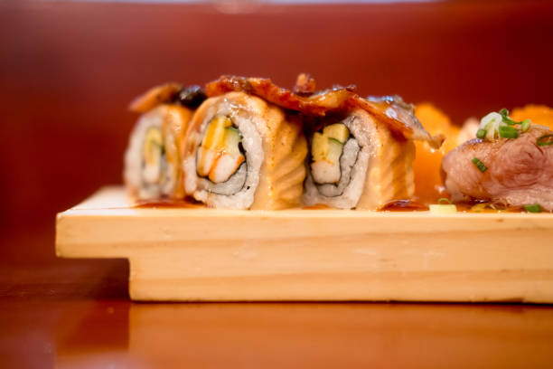 istock Salmon sushi rolls set served on wooden plate 1157732160