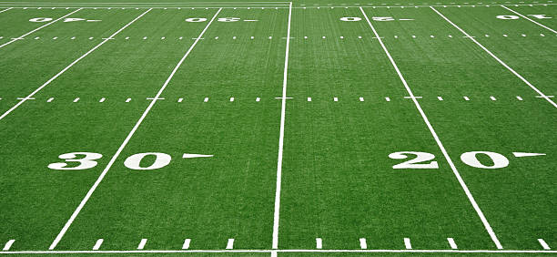 Twenty and Thirty Yard Line on American Football Field 20 and 30 Yard Line on American Football Field sports field photos stock pictures, royalty-free photos & images