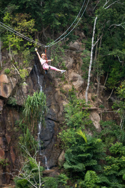 istock Carefree woman having fun while rappelling from a zip line. 1157735422