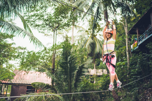 istock Happy woman enjoying while walking on zip line in nature. 1157735540