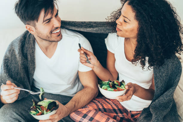 istock Couple in love eating salad 1157736697