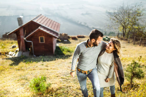 istock Happy embraced couple talking while walking up the hill. 1157739663