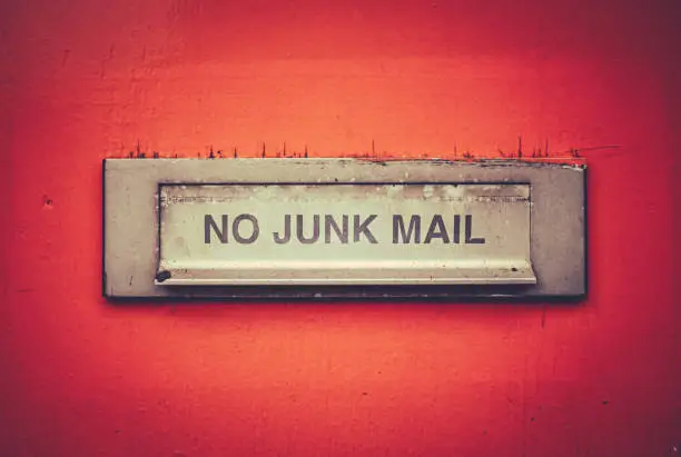 A Letterbox On A Grungy Orange Door With A No Junk Mail Sign