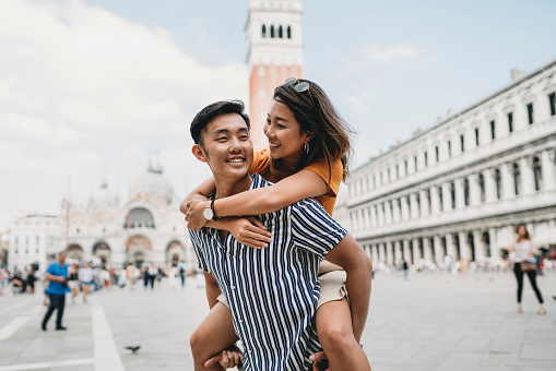 Young adult asian couple exploring Venice together, Italy