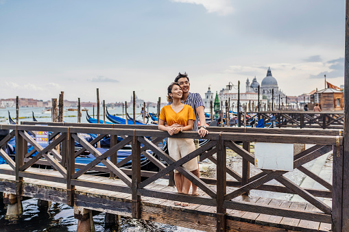Young adult asian couple together in Venice, Italy