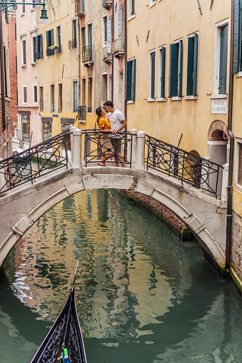 Young adult asian couple kissing in Venice