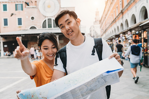 Young adult asian couple exploring Venice, Italy