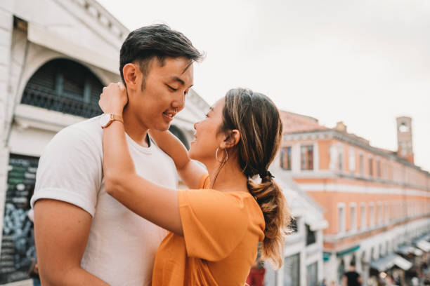 Young adult asian couple kissing in Venice Young adult asian couple kissing in Venice venice italy grand canal honeymoon gondola stock pictures, royalty-free photos & images