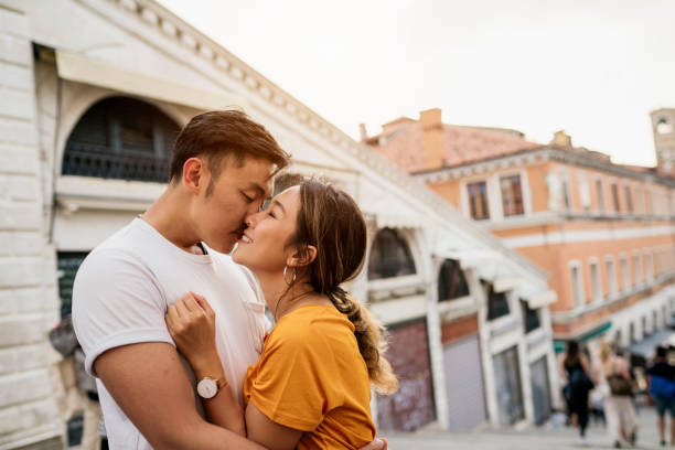 Young adult asian couple kissing in Venice Young adult asian couple kissing in Venice venice italy grand canal honeymoon gondola stock pictures, royalty-free photos & images