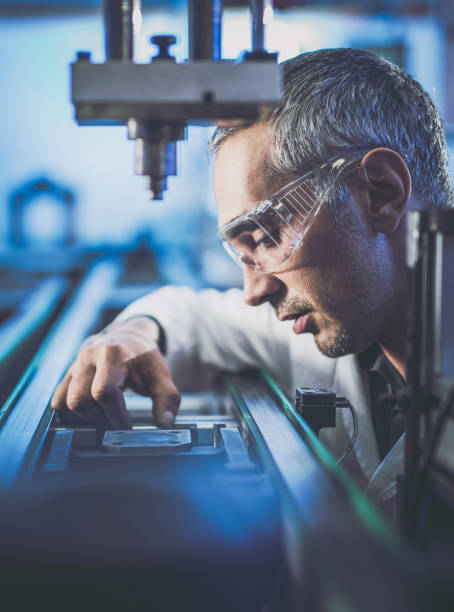 istock Focused mid adult engineer working on machinery in laboratory. 1157742533
