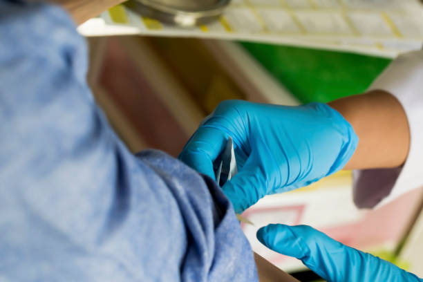 istock Male is holding hand while nurse is checking the vein 1157742648