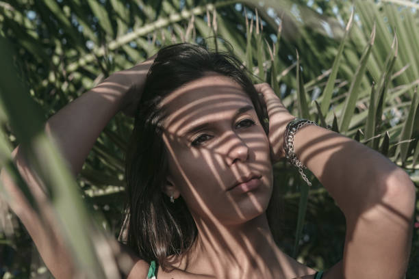 istock Woman with shadows on her face 1157743736