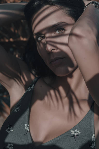 istock Portrait of woman between shadows 1157743738