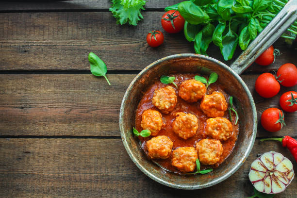 meatballs in tomato sauce and basil (meat dish). food background. top view. copy space meatballs in tomato sauce and basil (meat dish) chicken balls stock pictures, royalty-free photos & images