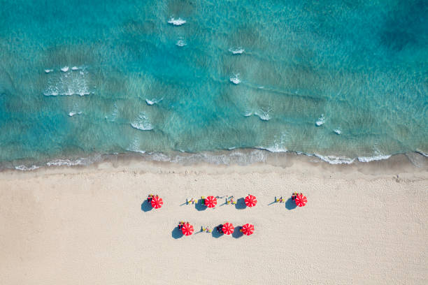 istock heavenly beach with red umbrellas 1157745326