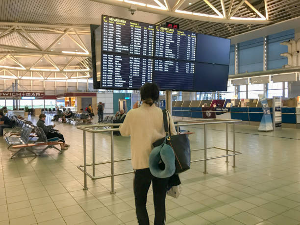 passengers walking in sofia airport terminal 2 - airport arrival departure board airport check in counter airplane imagens e fotografias de stock