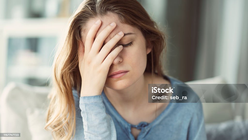 Young woman with headache Headache Stock Photo