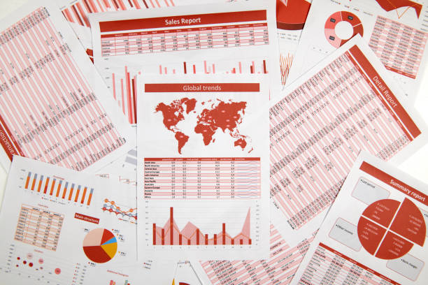 istock Business reports, data tables and charts - directly above view of office table workspace. 1157748352