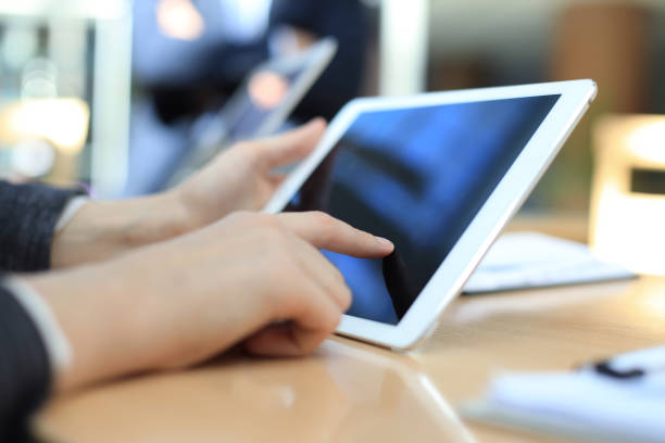 istock Image of human hand pointing at touchscreen in working environment at meeting. 1157748419