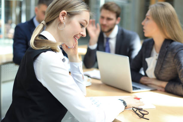 istock business woman with her staff, people group in background at modern bright office indoors. 1157748607