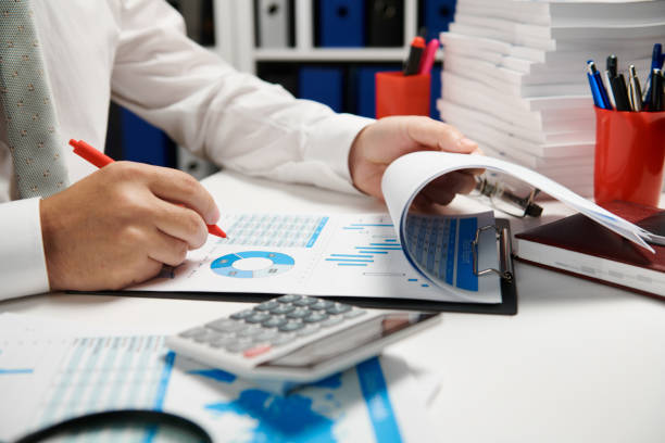 Businessman working and calculating, reads and writes reports. Office employee, table closeup. Business financial accounting concept. Businessman working and calculating, reads and writes reports. Office employee, table closeup. Business financial accounting concept. Master’s Degree in Accounting stock pictures, royalty-free photos & images
