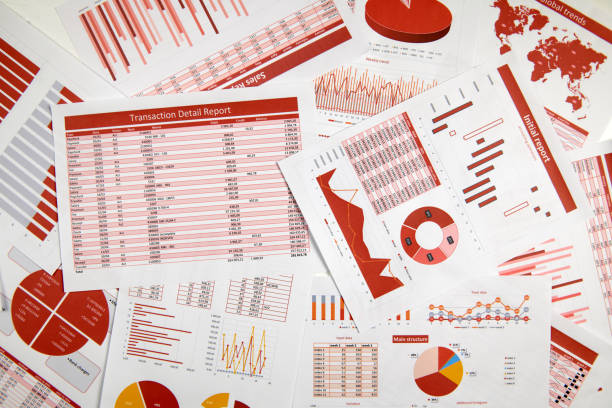 istock Business reports, data tables and charts - directly above view of office table workspace. 1157749717