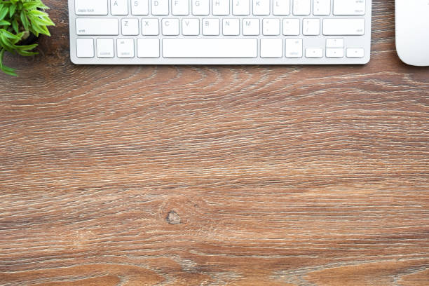 istock Wood office desk table with computer mouse and keyboard. Top view with copy space, flat lay. 1157749738