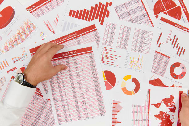 istock Business reports, data tables and charts - directly above view of office table workspace. 1157749972