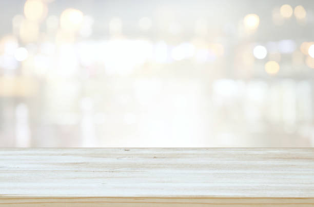 istock background of wooden table in front of abstract blurred window light 1157751359