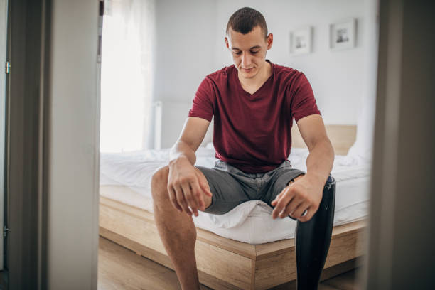 istock Man with amputee leg sitting on the bed 1157752641