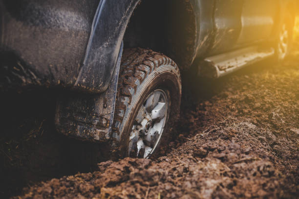 istock Close-up car tires are dirty on the mud. 1157752941