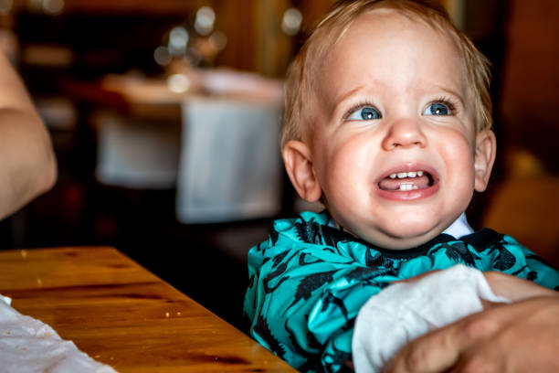 baby jongen huilen tijdens een familie diner. - foto’s van jongen stockfoto's en -beelden